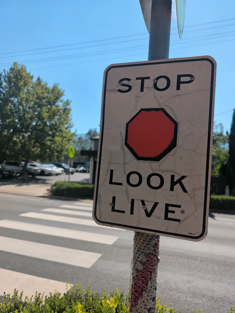 Faded Stop Look Live pedestrian safety sign on the Murrurundi crossing